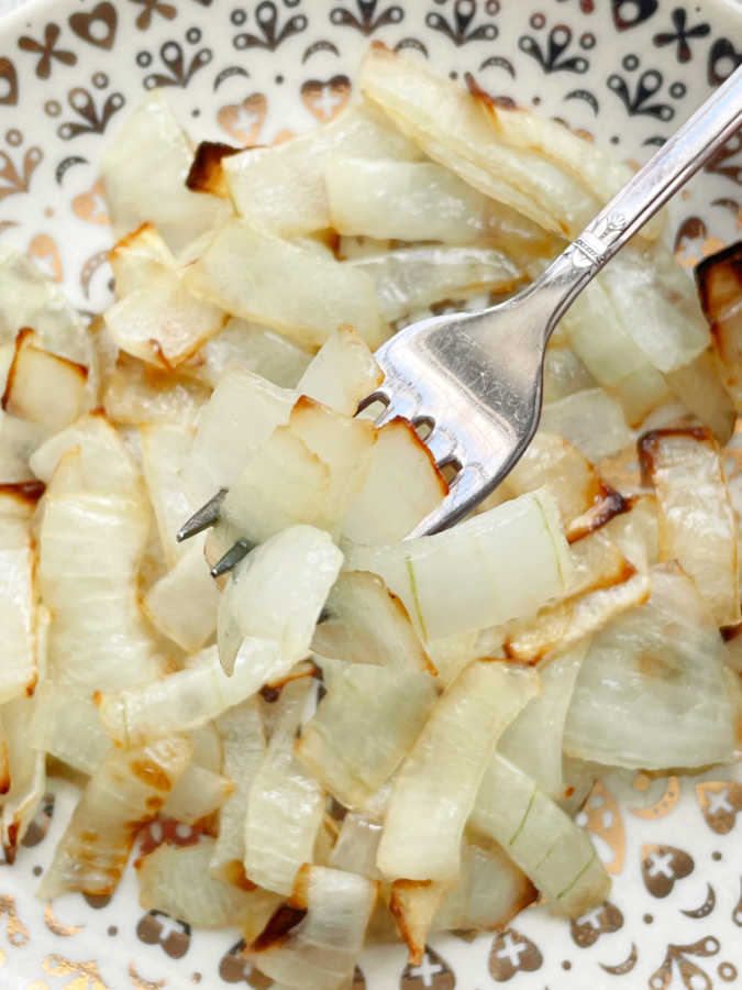 taking a bite of air fryer onions