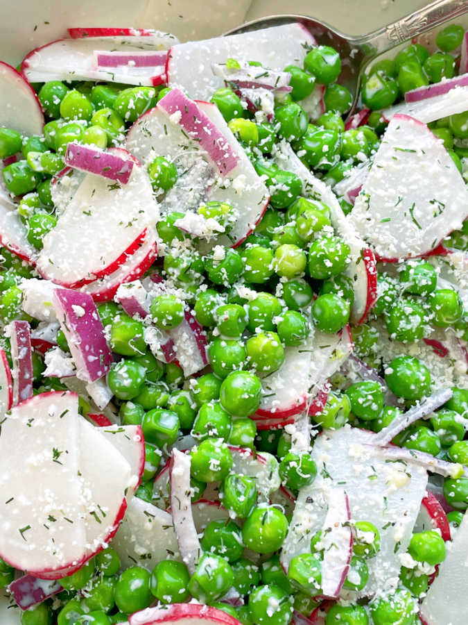 English pea salad in white serving bowl