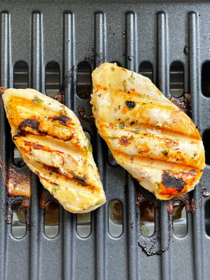 two grilled chicken breasts on the George Foreman Smokeless Grill