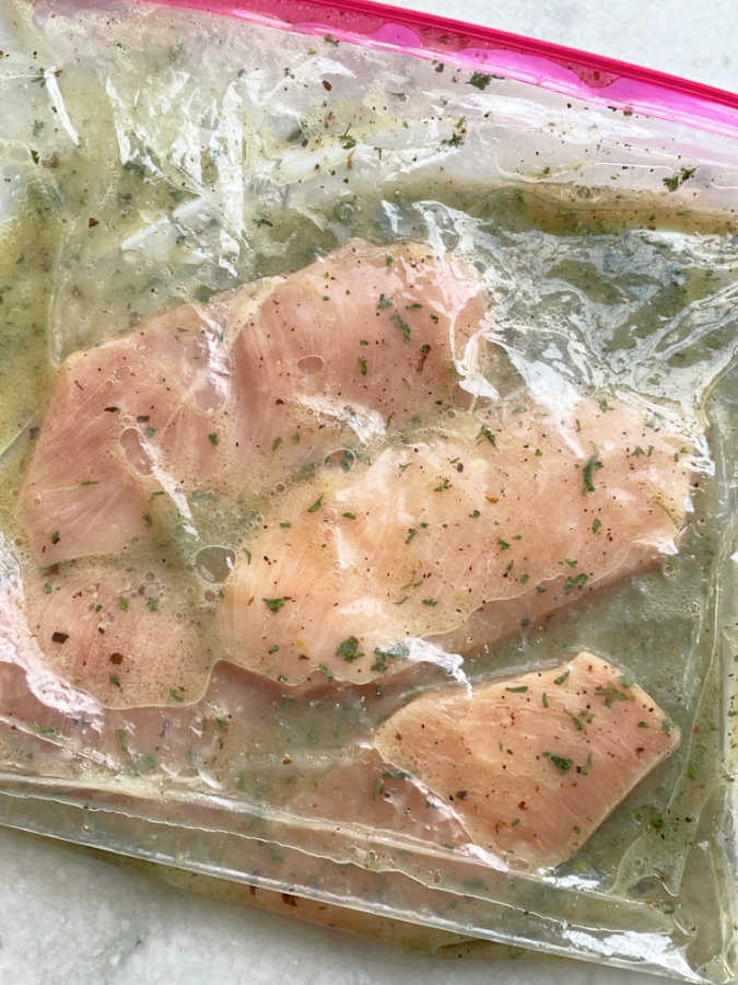 chicken breasts marinating in a Ziploc bag