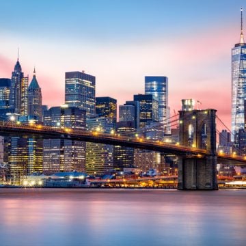 lower Manhattan skyline at sunset including Brooklyn bridge