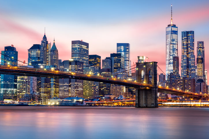 lower Manhattan skyline at sunset including Brooklyn bridge