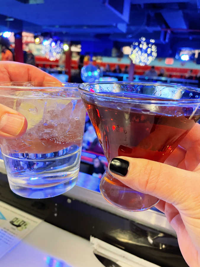 toasting cocktails including a Manhattan at Ellen's Stardust Diner in NYC
