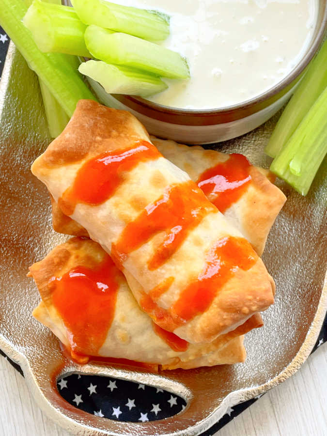 buffalo chicken egg rolls drizzled with buffalo sauce