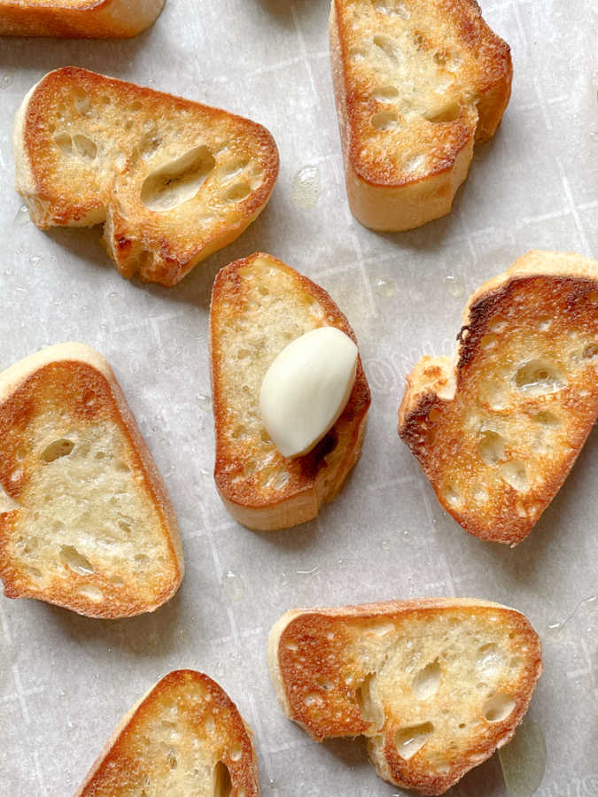 baguette slices ready to be rubbed with a clove of garlic