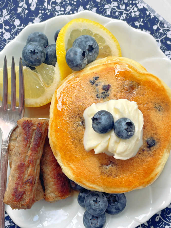 lemon blueberry pancakes topped with butter and blueberries