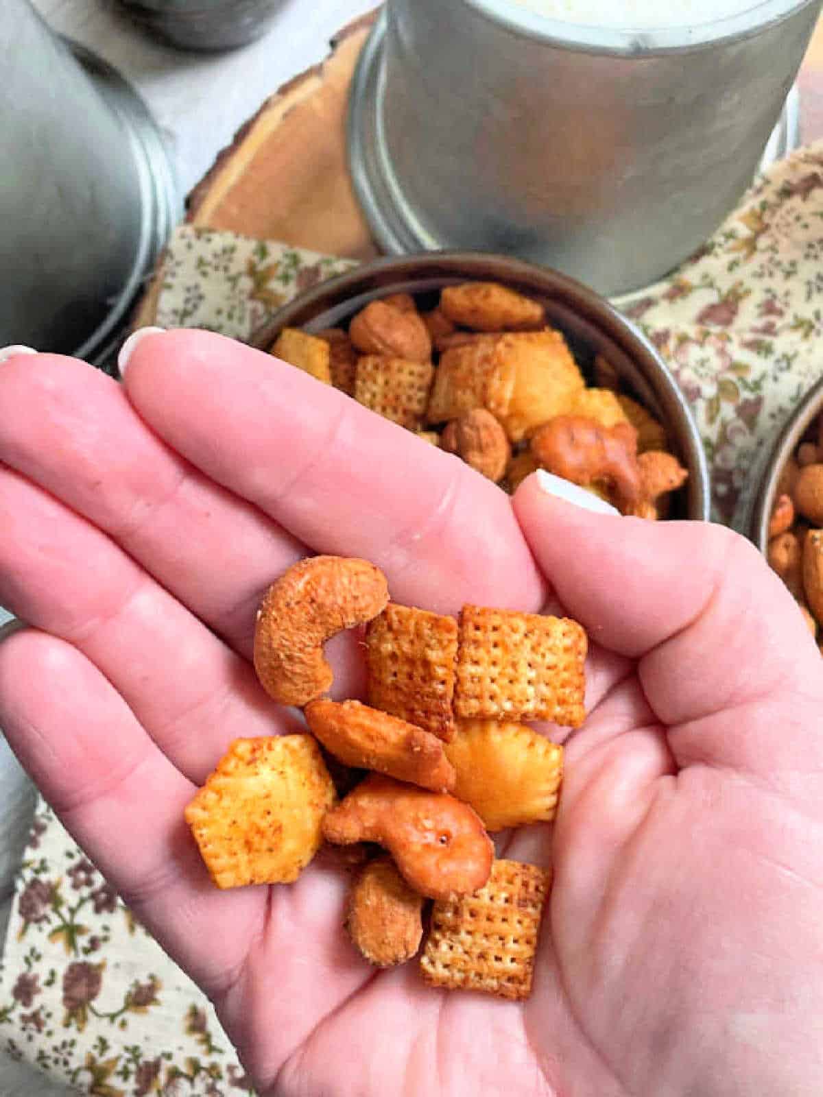 showing a handful of air fryer Chex mix