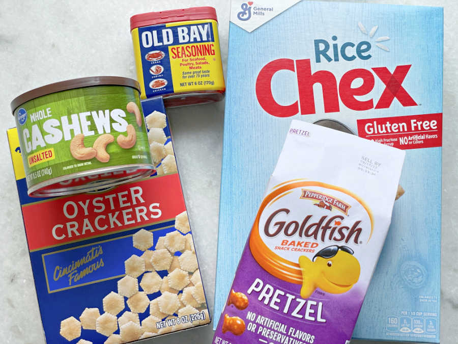 ingredients in air fryer chex mex, including - rice chex, pretzel goldfish, oyster crackers, cashews and Old Bay Seasoning