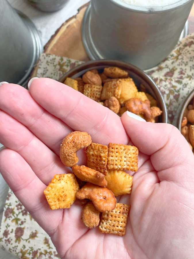 holding a handful of air fryer chex mix