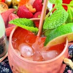 a bourbon mule in a copper mug garnished with fresh mint and lime wedge