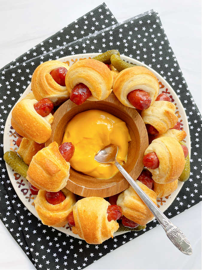 a plate full of air fryer pigs in a blanket made with crescent dough