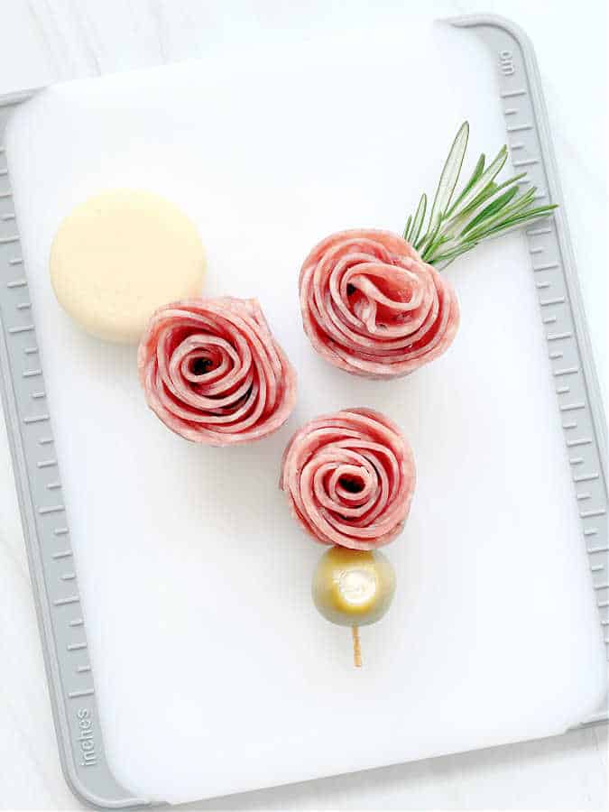 salami rosebuds displayed on a cutting board