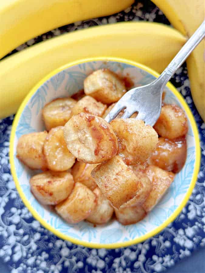 taking a bit of caramelized air fryer bananas