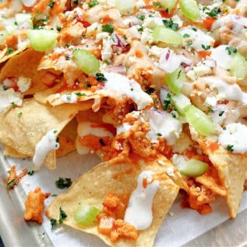 baked buffalo chicken nachos on a sheet pan