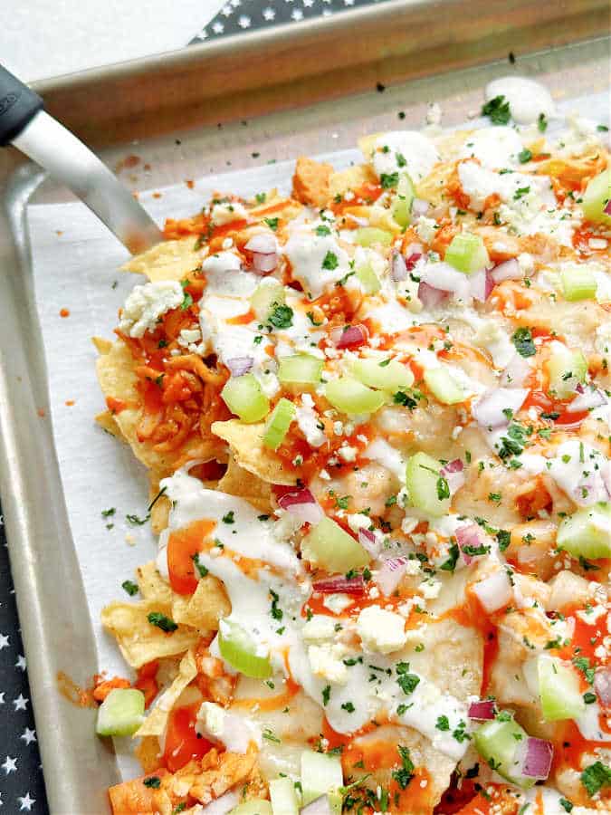 serving the buffalo chicken nachos from the sheet pan