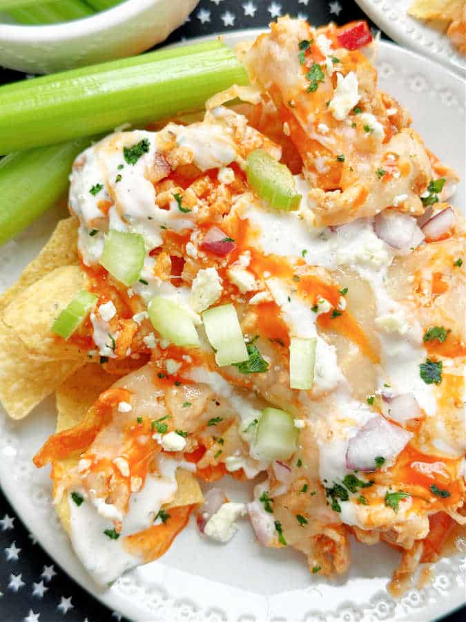 plated buffalo chicken nachos with a side of celery