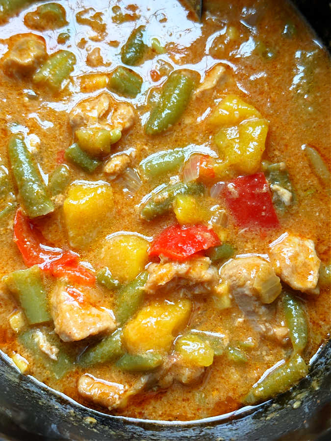 fully cooked pork curry in the slow cooker insert