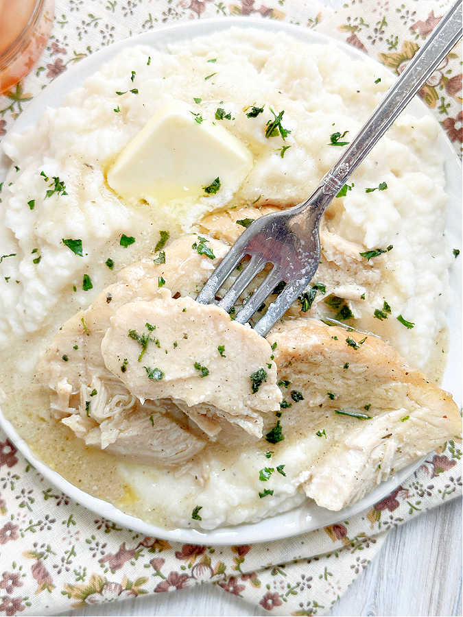 taking a bite of the tender roast turkey breast cooked from frozen in the crock pot