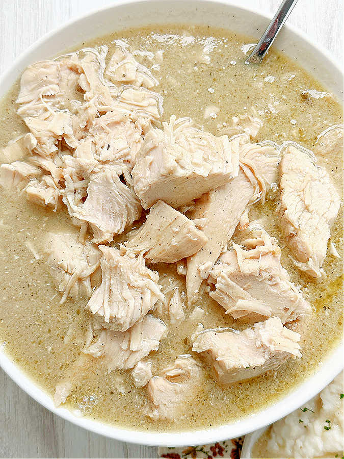 a bowl full of cooked from frozen turkey breast and gravy