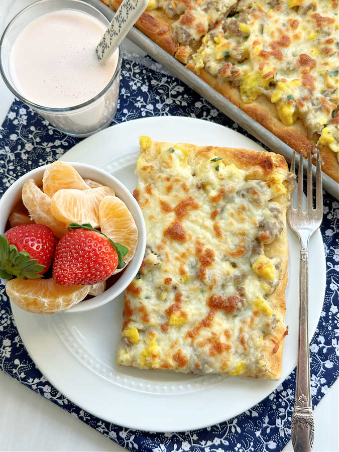 school breakfast pizza plated with fresh fruit