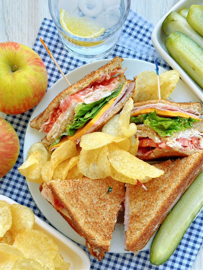 clubhouse sandwich with a side of potato chips