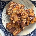 a stack of three squares of milk brownies on a small plate