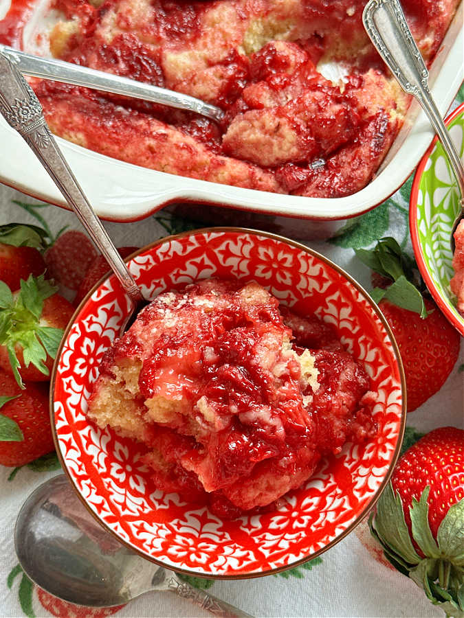 a serving of strawberry spoon cake in a red and white bowl