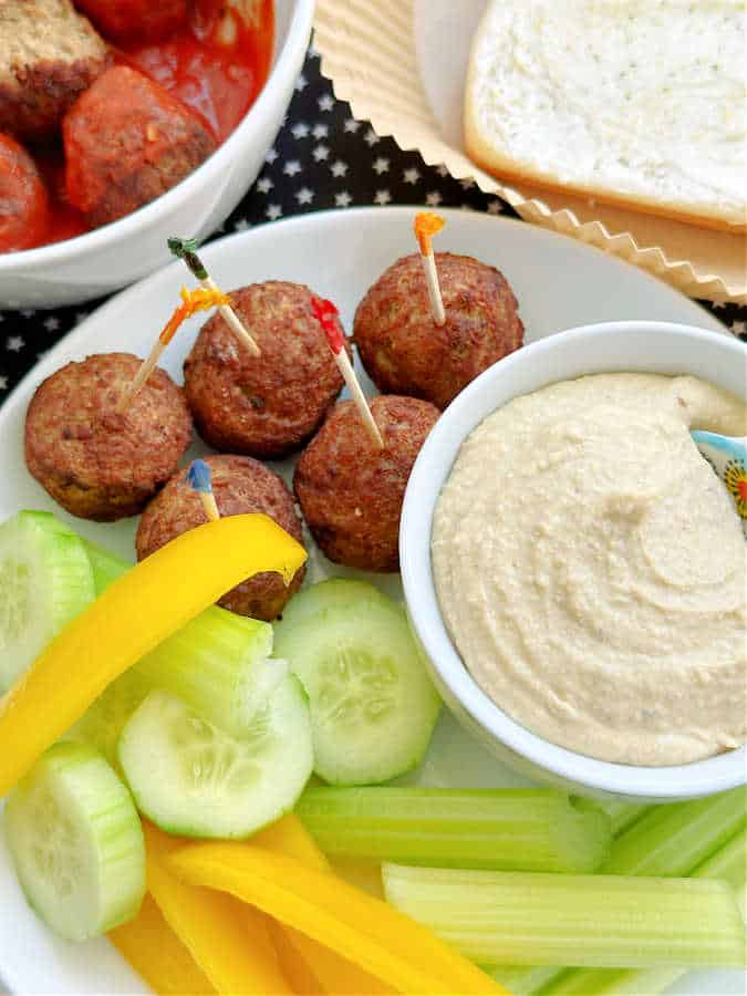 air fryer frozen meatballs plated with fresh veggies and hummus for dipping