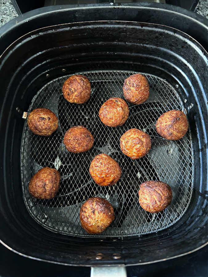 cooked meatballs in the air fryer basket