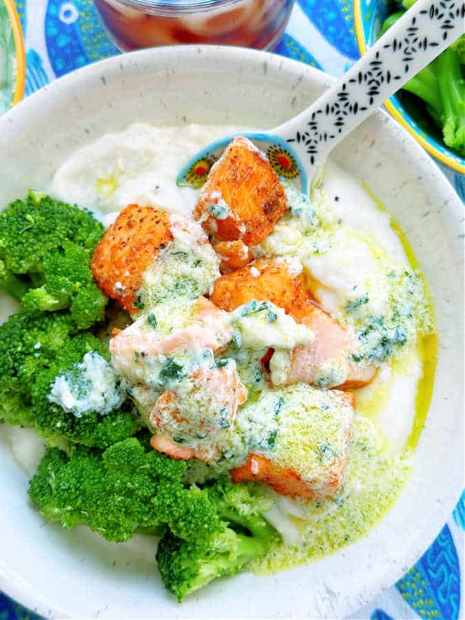 air fryer salmon bites bowl topped with creamy garlic sauce