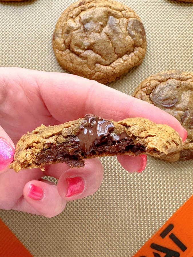 taking a bite of a warm espresso chocolate chip cookie