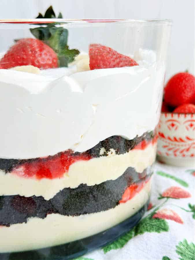 side view of strawberry banana pudding in trifle bowl to show all the layers