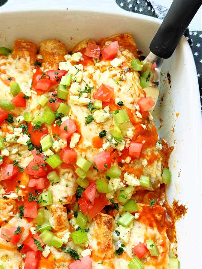 serving the buffalo chicken enchiladas out of the baking dish