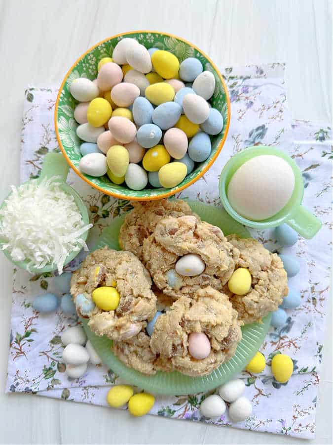 mini egg cookies on a green plate surrounded by more Cadbury mini eggs and coconut