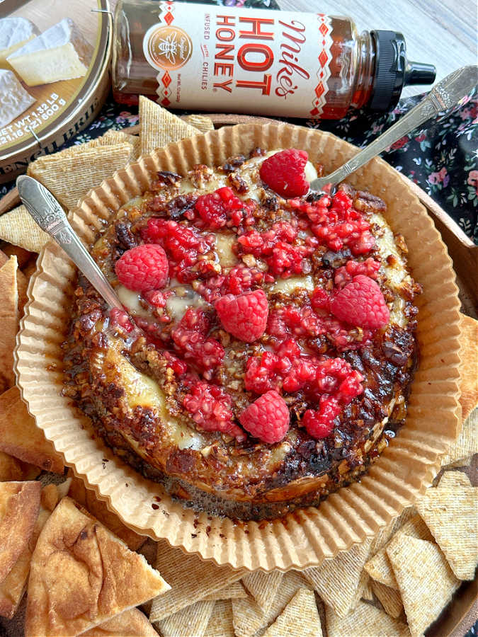 air fryer brie topped with honey, pecans and raspberries