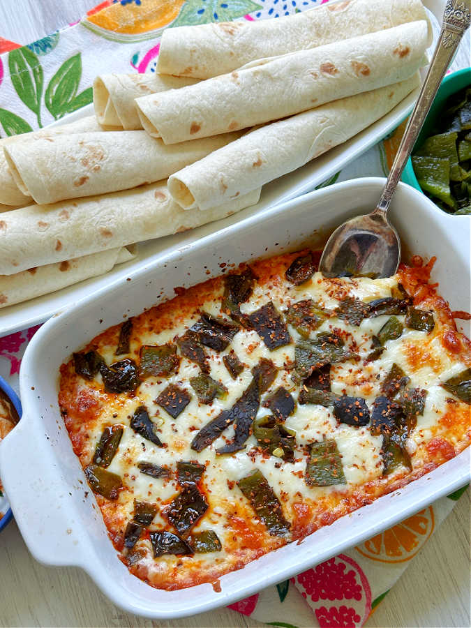 queso fundido con chorizo in a dish ready to serve with warm flour tortillas