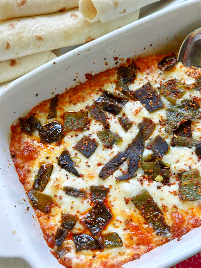 warm queso fundido in a dish ready to serve with tortillas