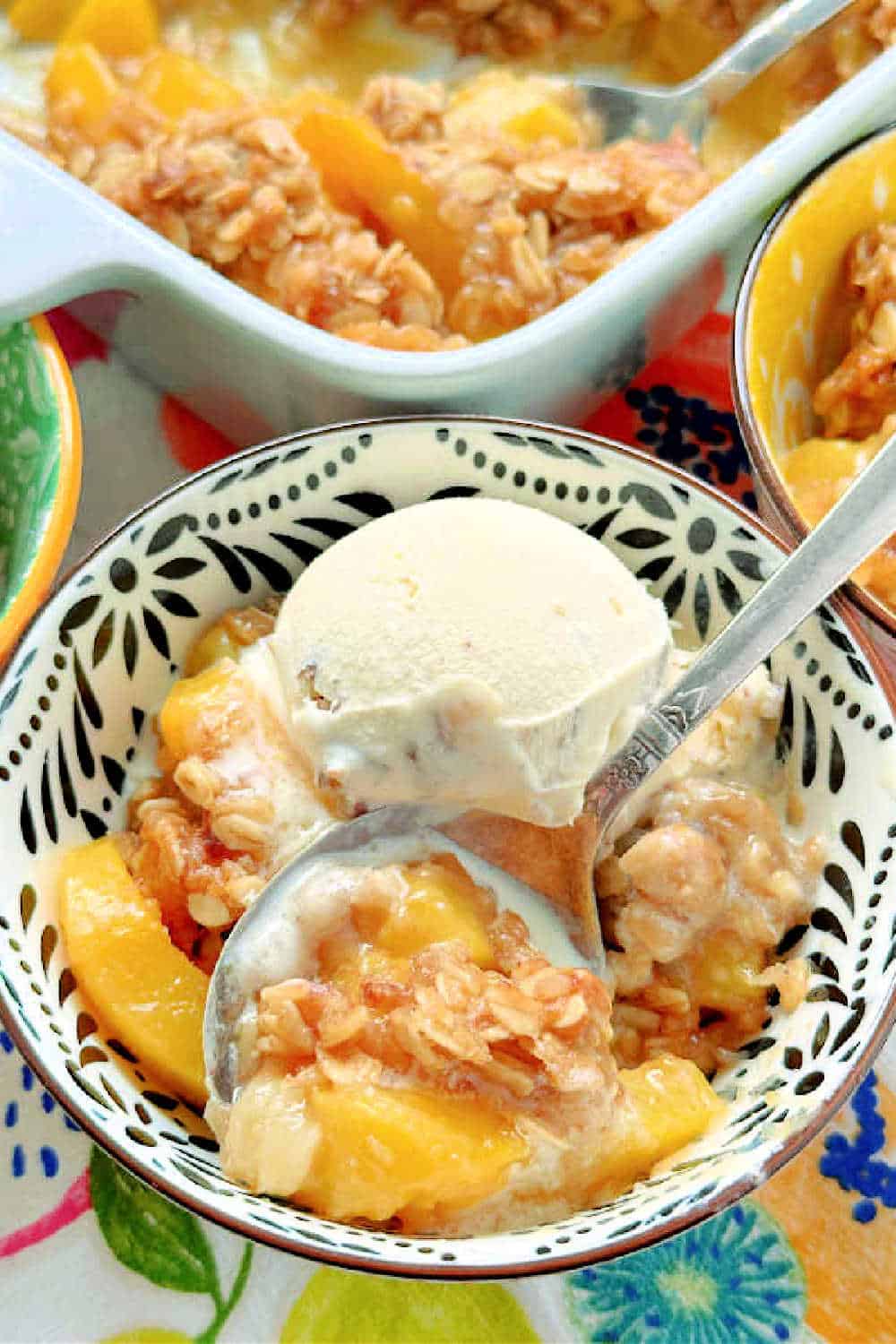 Bourbon Peach Crisp is the perfect dessert to show off the season's best peaches, kissed with bourbon and maple syrup flavor and the most delicious crumble topping. via @foodtasticmom
