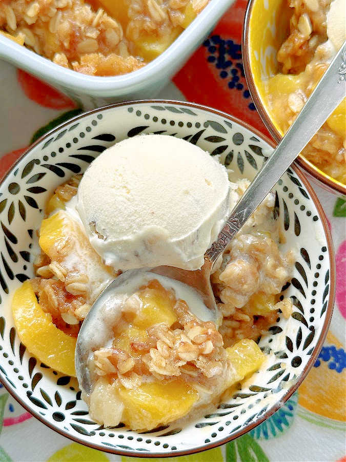 Bourbon Peach Crisp is the perfect dessert to show off the season's best peaches, kissed with bourbon and maple syrup flavor and the most delicious crumble topping. 