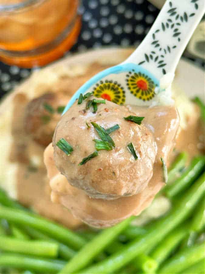 taking a bite of frozen crock pot meatballs