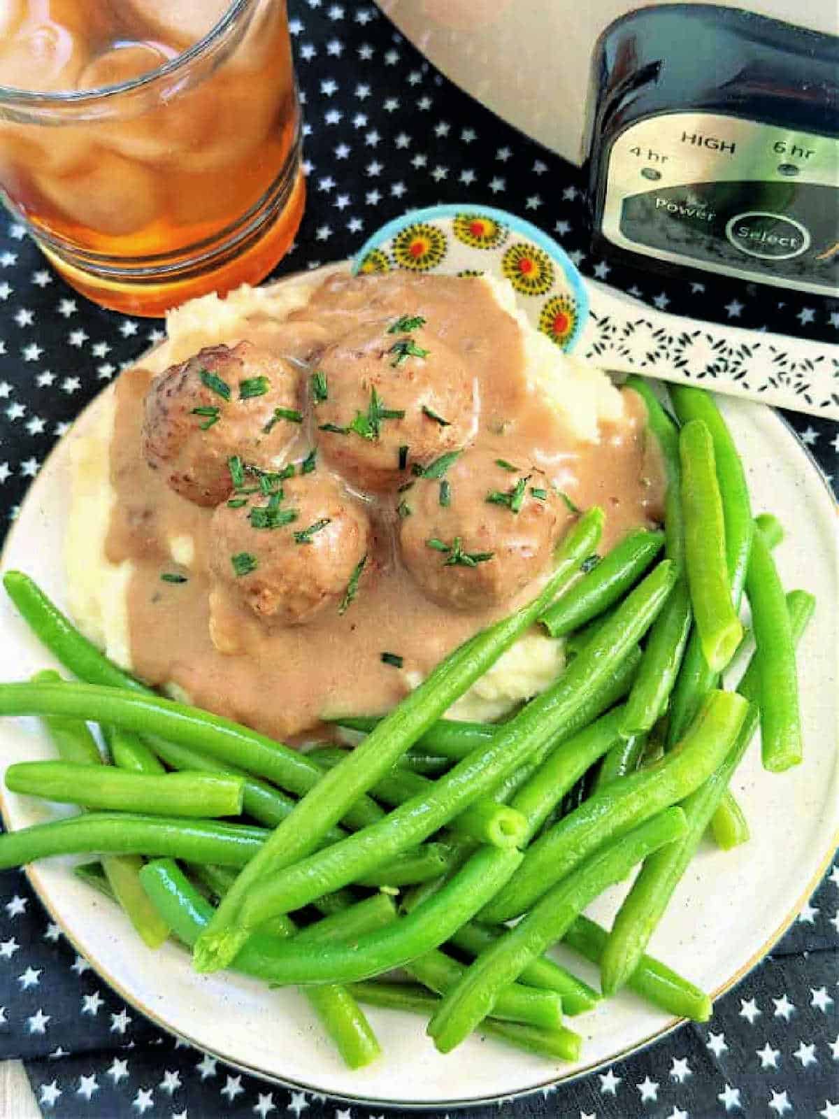 crockpot frozen swedish meatballs plated with mashed potatoes and green beans