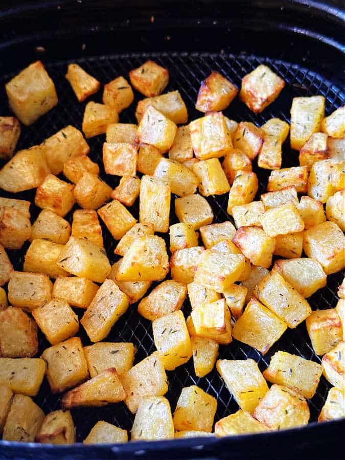 cooked pumpkin in the basket of an air fryer