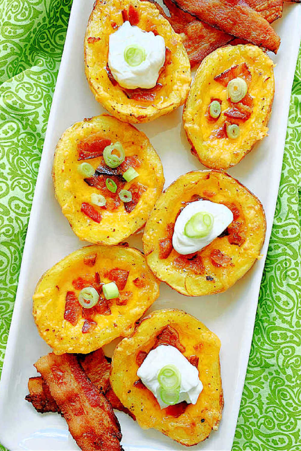 These Air Fryer Potato Skins are even better than restaurant skins. Start in the microwave, brush with bacon fat, then air fried. via @foodtasticmom