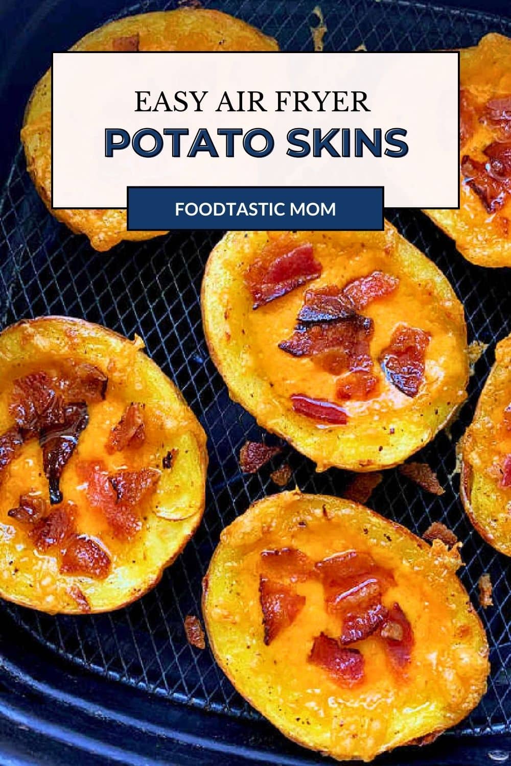 cooked potato skins topped with melted cheddar and cooked bacon in the basket of an air fryer