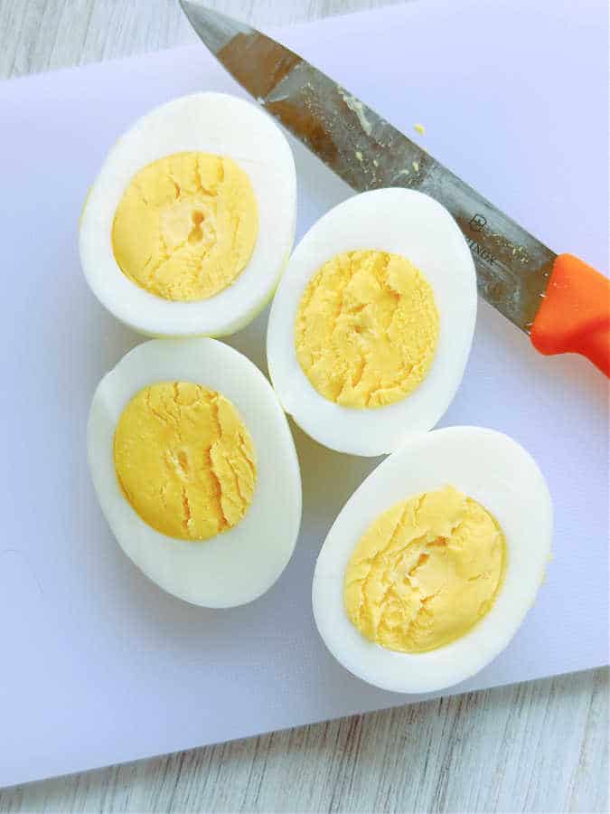 Picture showing how to slice hard boiled eggs to make deviled eggs
