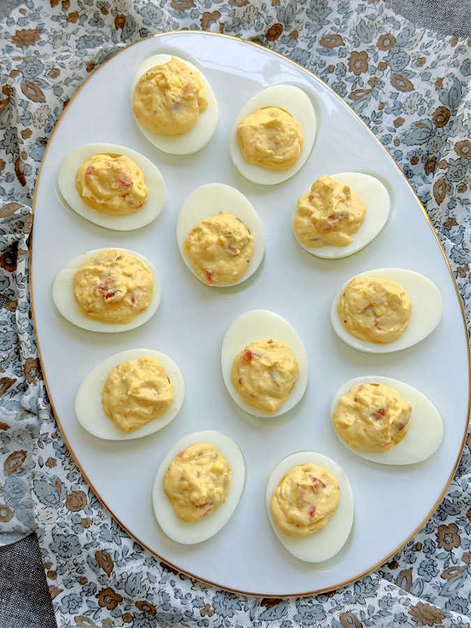 a plate of 12 deviled eggs with relish