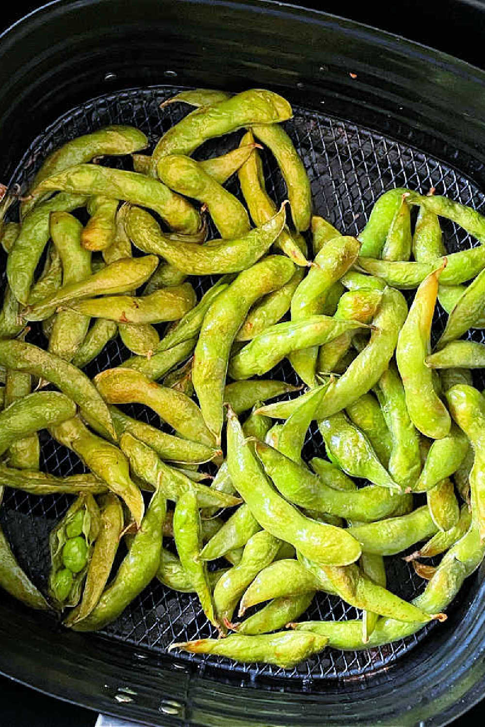 Air Fryer Edamame is a healthy and delicious snack that is ready in just a few minutes and as simple as opening a frozen bag of soy beans. via @foodtasticmom