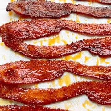 This easy candied bacon recipe combines brown sugar and spices with a splash of bourbon to easily brush on the bacon before baking.