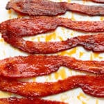 freshly made bacon candy laying on a parchment paper lined sheet pan