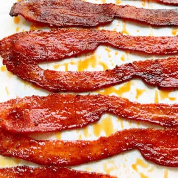 freshly made bacon candy laying on a parchment paper lined sheet pan